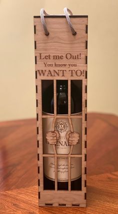 a wine bottle in a wooden crate with the words let me out, you know you want to