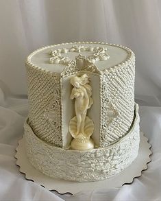 there is a cake that has been decorated with white frosting