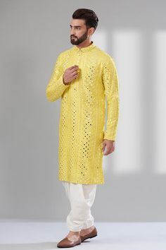 Aureolin yellow long sleeves kurta in silk base with all over diamond pattern mirror and thread work.
Components: 1
Pattern: Embroidery
Type Of Work: Mirror Work, Thread Work
Neckline: Mandarin Collar
Sleeve Type: Long Sleeves
Fabric: Silk, Lining: Cotton
Color: Yellow
Other Details: 
Attached cotton lining
Side slits
Note: The dhoti pant worn by the model is not for sale
Occasion: Mehendi and Puja, Sangeet - Aza Fashions Embroidery Mirror Work, Embroidery Mirror, Kurta For Men, Dhoti Pants, Yellow Silk, Pattern Embroidery, Silk Embroidery, Mirror Work, Thread Work