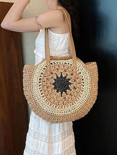 a woman wearing a white dress is holding a straw bag