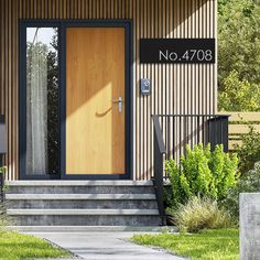 the front door of a house with wooden siding