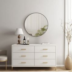 a white dresser with a round mirror above it