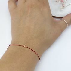 In many cultures, red string bracelets are traditionally used as a symbol of protection, good luck, or blessing. In my native Argentina, red thread bracelets are used to ward off evil spirits. It's very common to see kids and adults wearing a red thread on their wrists at all times. These bracelets are my modern interpretation of a classic good luck charm.  They are simply the perfect little gift for everybody in your list (including you!) These small bracelets may look delicate but they are actually very durable. We use nylon and/or polyester thread so they are super strong and water resistant. Once you put it on, just leave it on! They come ready for gift giving and we will include a little card explaining the meaning of these bracelets. ∙ ∙ ∙ ∙ ∙ ∙ S I Z E S Small (kids 3-7 yrs old): 5" Red Bracelets With Tiny Beads As Gift, Red Minimalist Bracelets With Adjustable Cord, Minimalist Red Bracelets With Adjustable Cord, Minimalist Red Bracelet With Adjustable Cord, Minimalist Braided Bracelet With Tiny Beads For Gifts, Minimalist Braided Bracelet With Tiny Beads As Gift, Minimalist Red Round Bead Bracelets, Dainty Red Bracelet With Sliding Knot, Red Friendship Bracelets With Sliding Knot