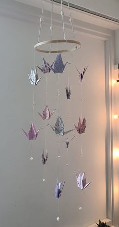 an origami mobile hanging from the ceiling