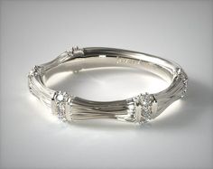 a white gold wedding band with three diamonds