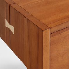 a close up of a wooden cabinet with a cross on the front and bottom section