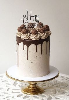 a birthday cake with chocolate frosting and sprinkles is on a table