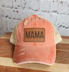 Being a mom doesn't mean you have to sacrifice your sense of style. Embrace the chic and trendy side of motherhood with our Trendy Mama Hat! This hat is designed exclusively for mamas who want to stay fashionable while juggling their busy lives. Crafted with both fashion and functionality in mind, our Women's Ponytail Hat features a cleverly designed opening at the back, allowing you to comfortably wear your ponytail or bun without compromising on style. Say goodbye to awkwardly squeezing your h Trendy Distressed Adjustable Hat, Trendy Adjustable Distressed Hat, Spring Adjustable Distressed Hats, Spring Distressed Adjustable Hat, Distressed Adjustable Baseball Cap For Spring, Trendy Distressed Baseball Cap, Spring Distressed Adjustable Baseball Cap, Distressed Adjustable Spring Baseball Cap, Trendy Adjustable Distressed Trucker Hat