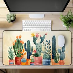 a computer keyboard sitting on top of a desk next to a plant covered mouse pad