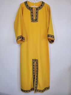 I love this one - can't tell if it's home made or not!  It's a Vintage 1970s Unknown Brand mustard yellow gold metallic rickrack floral trim long caftan/house dress! Measured women's bust 38" Metallic gold rickrack and daffodil-like flowers. Lace inside up the bottom hem. Fabric is textured almost like bark cloth. Superb tailoring! Looks like something Black Moth Super Rainbow would wear (they were wearing white when I saw them).  Or is it religious in nature? Is there a difference?  Please see our other listings for more vintage garments with new items added nearly daily. PLEASE check the measurements as vintage 70s clothing sizes may not comparable to contemporary sizes. Measurements: Label size: none present Shoulder-to-shoulder: 21" Chest across: 19" Sleeve from shoulder: 16" Length in Festival Long Sleeve Yellow Kaftan, Traditional Yellow Long Sleeve Tunic, Yellow Long Sleeve Festival Kaftan, Yellow Fitted Bohemian Kurta, Fitted Yellow Bohemian Kurta, Fitted Yellow Maxi Kurta, Yellow Fitted Maxi Length Kurta, Yellow Maxi Length Kurta, Yellow Fitted Long Kurta