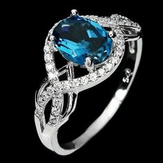 ~ Vibrant & Mystical London Blue Topaz Ring ~ Dive into the deep waters of elegance with this stunning deep sea blue topaz ring! Mounted in lustrous 18k white gold over pure sterling silver, this deep inky, oceanic blue, 1 1/2 carat gemstone creates a stunning ring. The beautiful solitaire is framed by a graceful halo of brilliant moissanites gems. The setting is lustrous 18k white gold over pure sterling silver. This is an elegant, graceful, cocktail ring, perfect for that specail event OR indu London Blue Topaz Ring, Luxury Wear, Sea Blue, London Blue Topaz, Blue Topaz Ring, London Blue, Topaz Ring, 2 Carat, Deep Sea