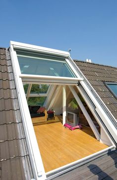 an open roof window on top of a house