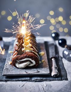 a chocolate cake with white frosting and sparklers