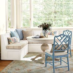 a living room filled with furniture next to a window covered in curtains and windowsills