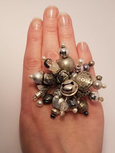 Elevate your style with this sophisticated, handcrafted silver and grey ring. Perfect for versatile, elegant accessorising and in keeping with this summer's trend of chunky jewellery with playful accents. The eye-catching bead cascade on a silver-plated base offers an elegant and refined touch to any outfit. Each ring is uniquely made, ensuring a distinct piece for any occasion.  This ring is adjustable to fit comfortably on various finger sizes (UK: M-S) see image of ring size table for other c Nickel Free Adjustable Rings For Parties, Adjustable Nickel-free Rings For Party, Gray Metal Jewelry For Gifts, Gray Metal Jewelry For Gift, Adjustable Gray Jewelry For Parties, Vintage Silver Rings For Party, Gray Jewelry With Silver Beads For A Gift, Gray Jewelry With Silver Beads For Gifts, Adjustable Silver Beaded Rings As Gift