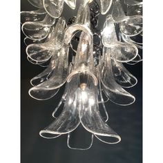 a chandelier made out of wine glasses hanging from it's center point