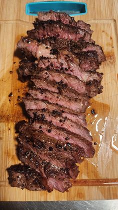 the steak is sliced up and ready to be served on the grilling board for consumption