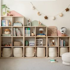 there is a book shelf with many books and toys on it in the room,