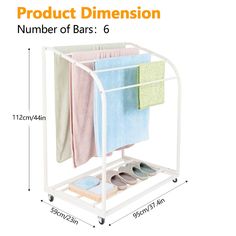 a white rack with three pairs of shoes and two towels hanging from it's sides