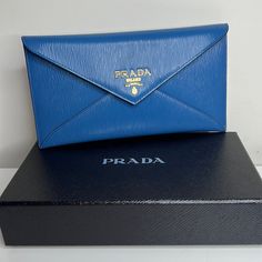 Just Purchased In Italy This Is A Gorgeous Prada Slim Envelope Wallet In Cobalt Blue Leather! Can Also Be Used As A Clutch. Stunning!!!!!! Gold Hardware. Fits Credit Cards And Perfect To Hold Cash Or Receipts. Has A Zip Pocket On The Back For Coins. Comes With Box And Authenticity Certificate. Makes A Gorgeous Gift! All Brand Brand New!! Super Pretty! Blue Is Even More Beautiful In Person. Designer Blue Bags With Card Slots, Blue Designer Bags With Card Slots, Luxury Blue Wallet For Formal Occasions, Designer Blue Leather Clutch, Modern Blue Clutch For Formal Occasions, Luxury Blue Clutch For Travel, Designer Travel Wallet In Envelope Shape, Designer Envelope Wallet For Travel, Designer Travel Envelope Wallet