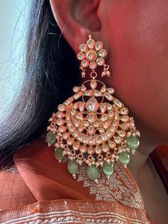 These gorgeous wedding Kundan earrings will add a perfect charm to your occasion wear. You will definitely fall in love with this beauty and it will make you stand out among the crowd. Pachi Kundan Length 9.5cms Width 6 cms Weight 68 grams a pair Luxury Green Chandbali Bridal Earrings, Luxury Green Bollywood Jhumkas, Fusion Kundan Bridal Earrings For Weddings, Fusion Style Kundan Bridal Earrings For Wedding, Green Meenakari Bridal Earrings For Reception, Green Bridal Earrings For Reception On Diwali, Green Bridal Earrings For Reception During Diwali, Green Bridal Earrings For Reception At Diwali, Fusion Style Wedding Danglers With Cutdana