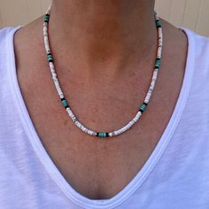 This Native American inspired beaded heishi necklace is made with natural white buffalo turquoise from Nevada, blue green turquoise, black onyx, and sterling silver spacer beads.  The beads are uniform in size, making for a clean flowing pattern of semi precious gemstones. Modeled in both 18" and 20". The AAA grade white buffalo turquoise beads are beautiful shades of gray and white polished to a fine quality semi gloss luster that compliments that of the green turquoise and black onyx.  White B White Buffalo Turquoise Jewelry Necklaces, White Heishi Beads Artisan Jewelry, White Artisan Heishi Bead Jewelry, White Heishi Beads Hand-strung Necklaces, White Heishi Beads Necklaces Hand-strung, White Hand-strung Heishi Bead Necklaces, Hand-strung White Heishi Bead Necklaces, Southwestern White Round Beads Jewelry, White Southwestern Style Round Bead Jewelry