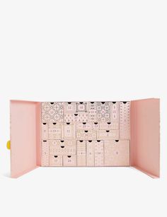 the inside of a pink box with many compartments and numbers on it's sides