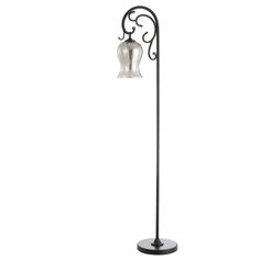 a black metal floor lamp with a glass shade