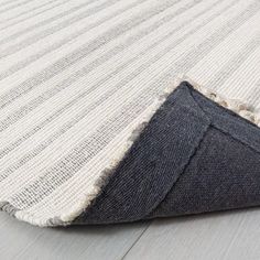 an area rug with grey and white stripes