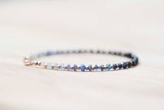 This sweet, simple beaded bracelet features faceted blue sapphire rondelles that range from light to dark and back again, spaced by round gold filled beads. Finished with a gold-filled lobster clasp and findings. Another great piece for wearing alone, or stacking up with an armful of your favorite pretties! Also available with rose gold filled or sterling silver instead of gold components... please make your selection from the drop-down menu. Sapphire is the birthstone for September. This is a f Dainty Blue Bracelets With Faceted Beads, Dainty Blue Beaded Bracelets With Faceted Beads, Dainty Blue Faceted Beaded Bracelets, Simple Beaded Bracelets, Ombre Bracelet, Blue Sapphire Jewelry, Adjustable Jewelry, Jewelry Beaded, Bracelet Blue