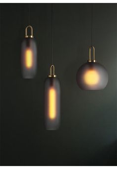 three lights hanging from the ceiling in a room