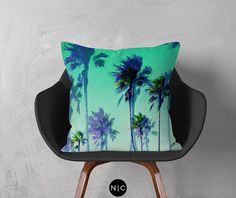 a pillow with palm trees on it sitting on a chair