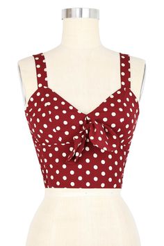 a red and white polka dot top on a mannequin