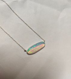 A pendant that is eye-catching and wonderfully unique. A mesmerizing shade of opal in a modern setting of 925 Sterling Silver, 18K gold polished. This pendant will bring gravitas to your everyday wear. Thanks for stopping by! Happy Shopping! H O W ~ T O ~ O R D E R  It's easy as 1, 2, 3! 1. Select options from the dropdown menu  2. Add to cart and proceed to checkout. C A R E ~ T I P S We don't want your special moment to fade. To maintain the quality of your new Misha Jewels jewellery, please: - Do not wear it to the pool, spa, or the beach  - Remove when sleeping, exercising, or doing other physically strenuous activities - Avoid contact with perfumes, body oils, and other chemicals, including household cleaners. - Do not use chemical jewelry cleaners - Gently polish with a soft, lint-fr Elegant Silver Jewelry With Pink Opal, Elegant Silver Pink Opal Jewelry, Iridescent Oval Sterling Silver Jewelry, Modern Cabochon Necklaces For Gifts, White Gold Opal Jewelry Gift, White Gold Opal Jewelry For Gift, White Gold Opal Jewelry As Gift, Ethiopian Opal Oval Pendant Jewelry Gift, Ethiopian Opal Oval Pendant With Gemstone