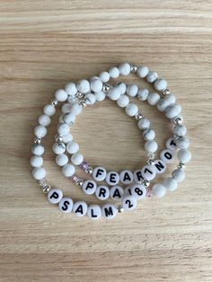 two bracelets with beads that say peace, pray and salam on the ends