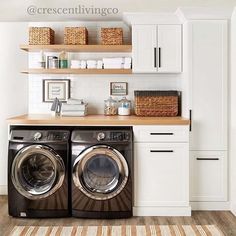 a washer and dryer in a white laundry room with open shelving on the wall