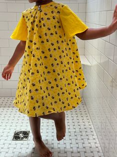 Get at least 2 years out of this dress! A wide back with buttons allows for incredible breathability and extended sizes. Super cool back to school dress, those dress is made to last with double seams and generous sizing. It's lined with 100% cotton and all cotton bumble bee print yellow fabric. Beautifully hand crafted in Richmond, VA.  We live in a very hot and very humid environment so I always try to make kids clothes that won't cling to the skin and allow a breeze to pass through.  Meterials Yellow Relaxed Fit Cotton Dress, Yellow Cotton Dress Relaxed Fit, Yellow Cotton Dress With Relaxed Fit, Yellow Cotton Sundress With Short Sleeves, Bumble Bee Dress, Bumble Bee Print, Bee Dress, School Dress, School Dresses