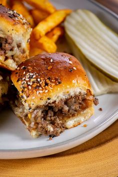 two hamburgers and french fries on a plate