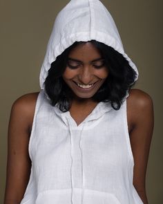 Put on your A-game in our signature sleeveless drawstring hoodie with a kangaroo pocket. Perfect as is or layer over your favorite tank top. Details:Made from 100% HempStraight fitOversized fitHood with adjustable drawstringFront kangaroo pocketsGarment length for Size M is 26 inchesRoselyn is 5'7" and is wearing size XS White Sleeveless Top With Drawstring, Sleeveless Top With Drawstring Hood For Spring, Summer Hooded Loungewear Tops, Hooded Top For Summer Loungewear, White Summer Hoodie Top, White Hooded Tops For Summer, Sleeveless Cotton Hoodie For Loungewear, White Drawstring Hooded Top For Summer, White Summer Top With Drawstring Hood