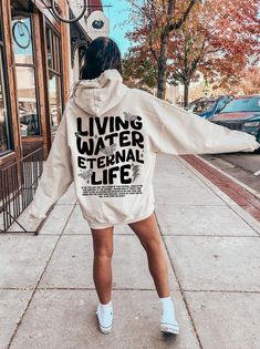 Living Water Eternal Life Hoodie, Aesthetic Christian Sweatshirt, Women's Religious Shirt, Bible Verse Shirt, Trendy Church Shirt, R118 ♥️ WELCOME ♥️ Looking for super soft, comfy, and high-quality clothes for your special days or loved ones? You've come to the right place! We absolutely love what we do and are dedicated to making your shopping experience just perfect. If you have any questions about our products, don't hesitate to reach out. We're here to help and will get back to you as soon as possible! 🔵 HOW TO ORDER  1️⃣Select the t-shirt size 2️⃣ Select the color 3️⃣ If you have, add your personalized designs, enter customization in "Add your personalization" field 4️⃣ Add to cart 5️⃣ Go back and Repeat for each size (to create a set ) ♻️ CARE INSTRUCTIONS  🟢 Wash item inside out i Grunge Hooded Top With Letter Print, Relaxed Fit Slogan Hoodie, Grunge Letter Print Hoodie, Grunge Hoodie Top With Letter Print, Grunge Hoodie With Letter Print, Relaxed Fit Hoodie With Slogan, Hooded Relaxed Fit Grunge Tops, Casual Hooded Slogan Tops, Leisure Letter Print Hoodie Top