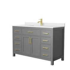 an image of a bathroom vanity with two sinks and gold faucets on it