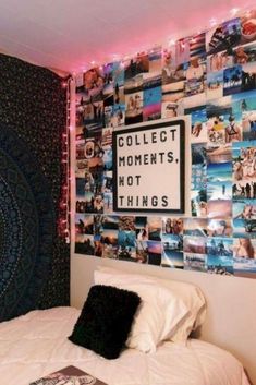 a room with a bed, lights and pictures on the wall above it that says collect moments not things