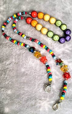 Keep your child's face mask always at hand with this fun rainbow colored beaded face mask lanyard, accented with colorful star shaped beads and silver lobster clasps that hook onto face mask ear loops. Lanyard Diy, Solar System Jewelry, Diy Lanyard, Mixed Media Necklace, Face Mask Lanyard, Mask Lanyard, Cute Face Mask, Rainbow Beads, Brass Necklace