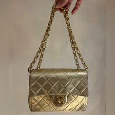 Vintage That Stands The Test Of Time, This Gold Mini Square Chanel Bag Has A Unique Shine That Is Quite Metallic With A Slight Sheen. Chanel Vintage Mini Square Bijoux Chain Flap Bag Features The Classic Quilt, 24k Gold Hardware, And Bijoux Chain. The 24k Gold Turn-Lock Opens To A Matching Gold Metallic Interior With Stitched Large Cc Logo Under The Flap. Condition: Minor Signs Of Wear That Are Natural With A Bag That Is Over 30 Years Old. From 1989-1992 Approximately. Dimensions: Height: 5" Width: 6" Depth: 2.5" Bijoux Chain Strap Drop: 20.5" Elegant Square Flap Bag For Party, Gold Double Flap Evening Bag, Classic Gold Flap Bag With Chain Strap, Gold Double Flap Bag For Everyday Use, Luxury Bags With Chain Strap For Gift, Luxury Bags With Chain Strap As Gift, Formal Gold Bag With Gold-tone Logo Plaque, Luxury Bag With Chain Strap As Gift, High-end Gold Bags For Everyday Luxury