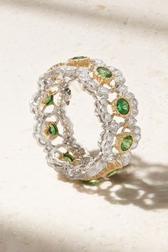 Buccellati's exquisite pieces are handcrafted in Italy by skilled artisans using centuries-old techniques. This 'Ghirlanda Eternelle' ring is crafted from 18-karat white gold in a crochet-inspired design and set with sparkling diamonds. The tsavorites are mounted in 18-karat yellow gold settings to showcase their vibrancy. Luxury Oval Tsavorite Jewelry, Luxury Tsavorite Emerald Ring For Formal Occasions, Luxury Tsavorite Emerald Ring, Luxury Multi-stone Emerald Ring For May Birthstone, Luxury White Gold Emerald Ring With Rose Cut Diamonds, Luxury Tsavorite Ring Jewelry, Luxury Emerald Ring For May Birthstone, Luxury Tsavorite Emerald Anniversary Ring, Luxury Tsavorite Emerald Ring For Anniversary