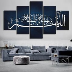 a living room with a couch and paintings on the wall in arabic writing, it is dark blue