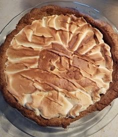 a pie sitting on top of a glass plate covered in frosting and icing