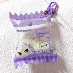 the keychain is attached to an animal shaped plastic case with two small bears on it