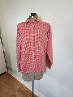 This vintage shirt is a fun addition to any wardrobe. Lands' End DIrect Merchants 55% cotton / 45% polyester The shirt features a red gingham plaid pattern. Tag size: ladies 14 Shoulder to hem length: 21.5 inches Sleeve length: 21.5 inches Chest: 42 inches The very top button is missing. This shirt is otherwise in great vintage condition with very light wear. Feel free to send me any questions! Casual Collared Gingham Shirt, Casual Gingham Collared Shirt, Classic Plaid Button-up Top, Preppy Plaid Cotton Top, Classic Plaid Tops For Daywear, Gingham Button-up Tops For Daywear, Preppy Plaid Collared Shirt, Preppy Collared Cotton Blouse, Preppy Plaid Cotton Shirt