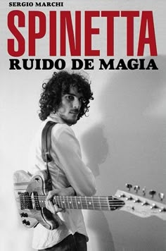 a man holding a guitar in front of a white wall with the words spinetteta ruud de magia on it